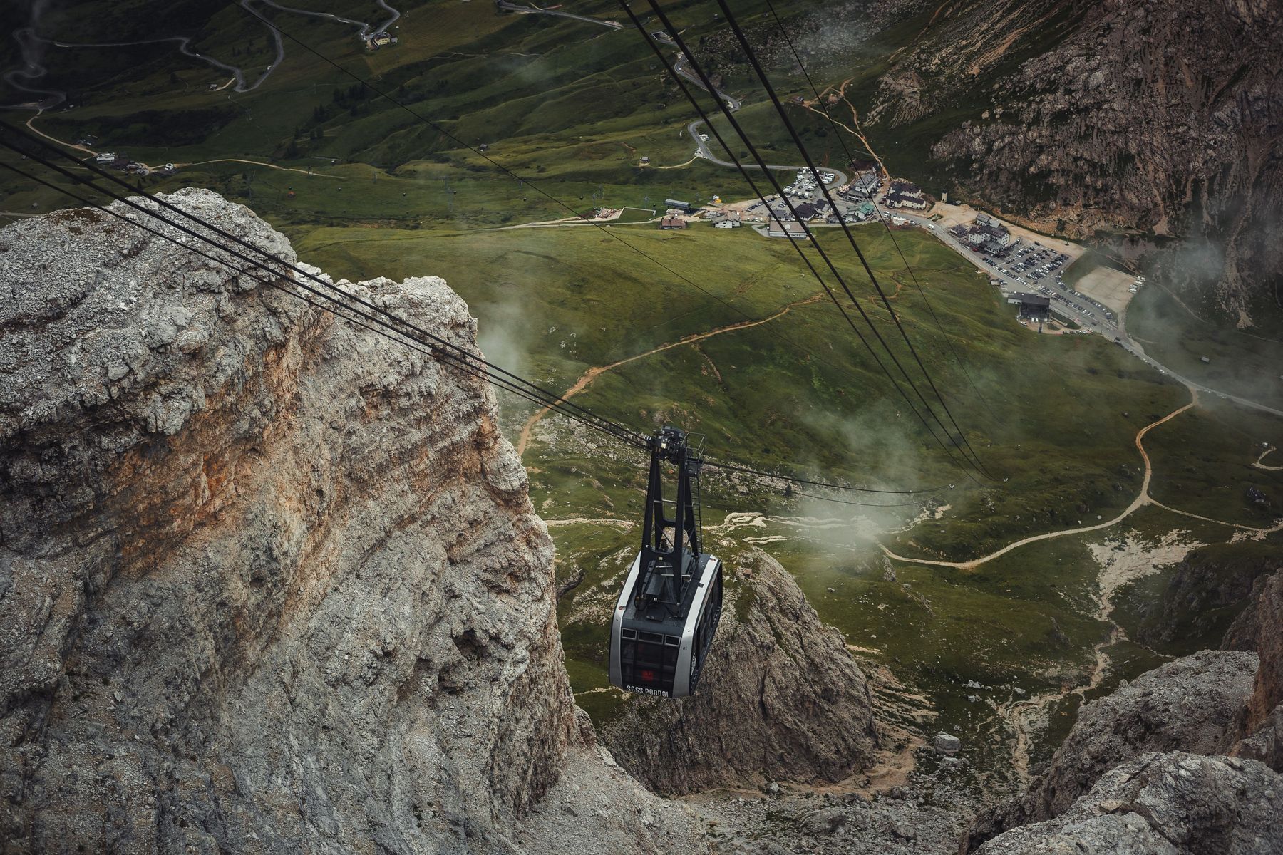 A cable car above a green valley