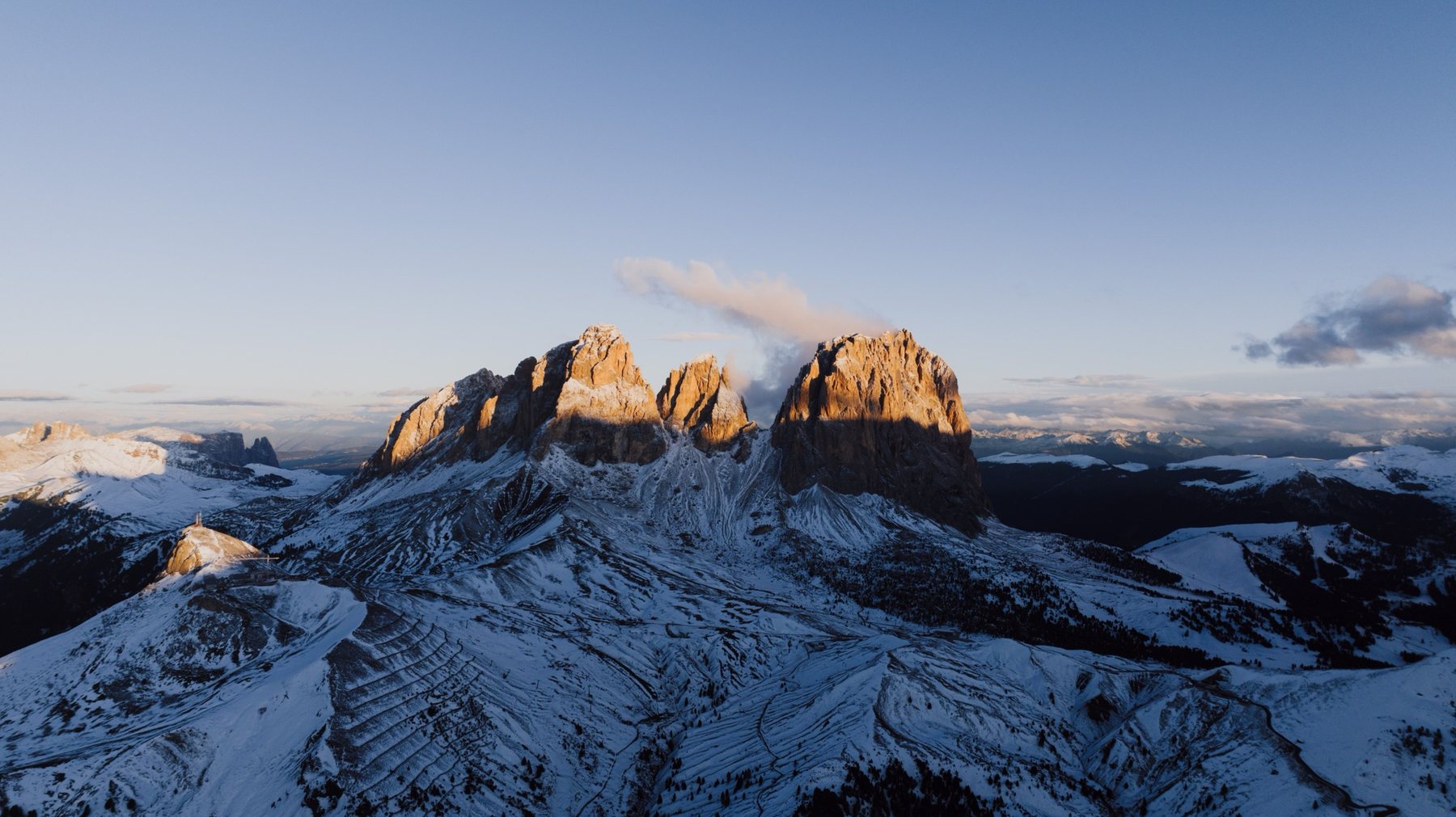 The Sassolungo group in first light, seen from the air
